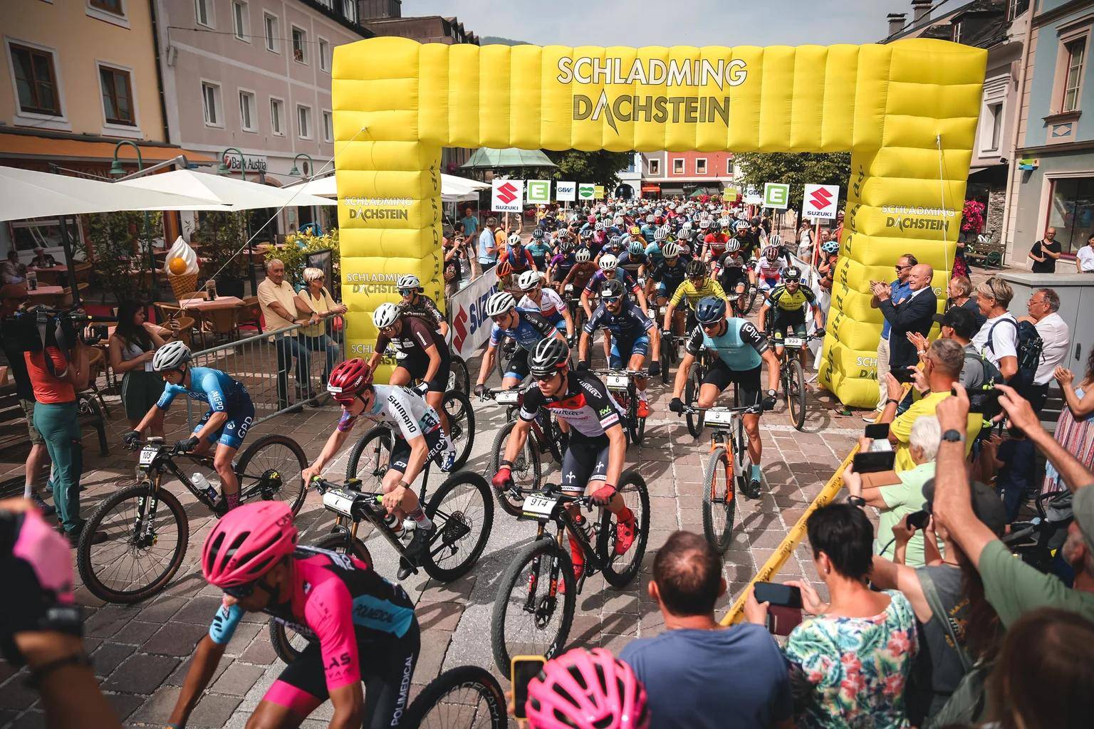 Cyclists riding through a street in Schladming during the Alpentour Trophy cycling race.