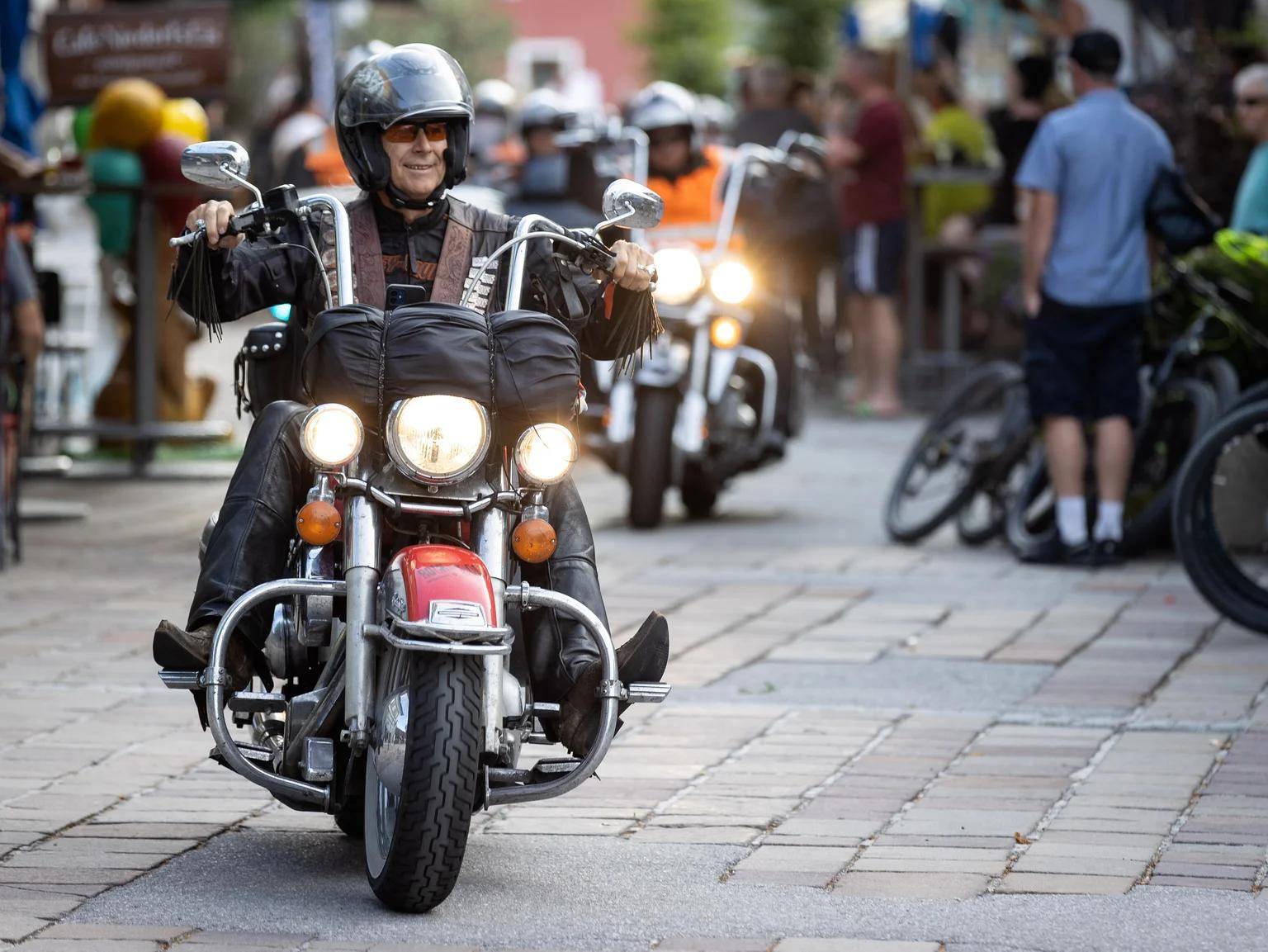 An older man on a Harley-Davidson bike during the charity motorcycle event.