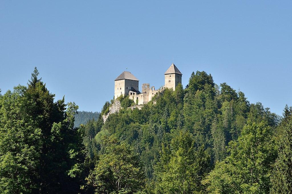 An old castle on the mountaintop in the forest.